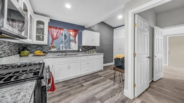 a kitchen with a stove a sink and a refrigerator