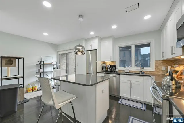 a kitchen with kitchen island a appliances and cabinets