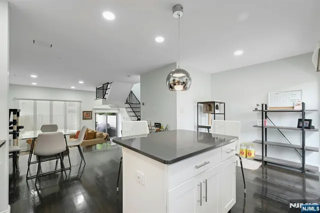 a large kitchen with a table and chairs