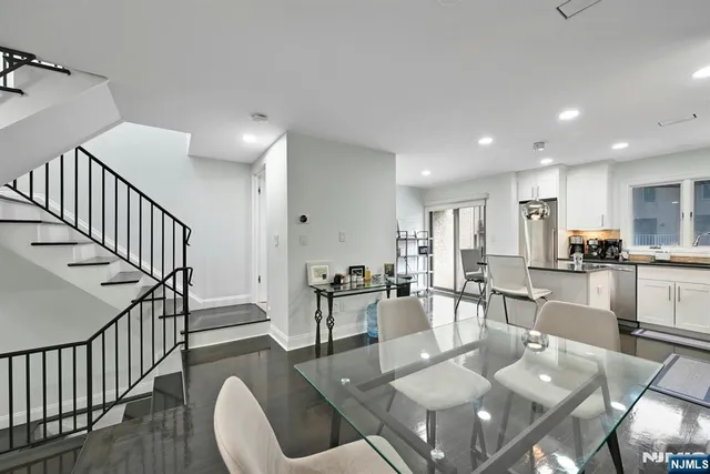 a living room with furniture a dining table and kitchen view