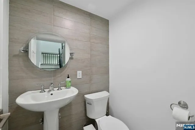 a bathroom with a sink a mirror and a toilet