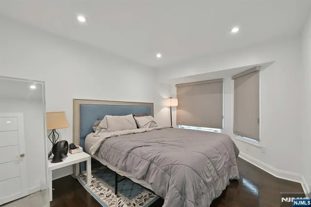 a bed room with a bed and a night stand