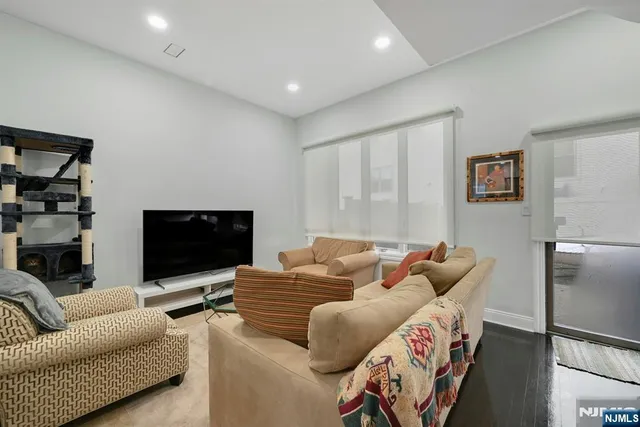 a living room with furniture flat screen tv and a couch