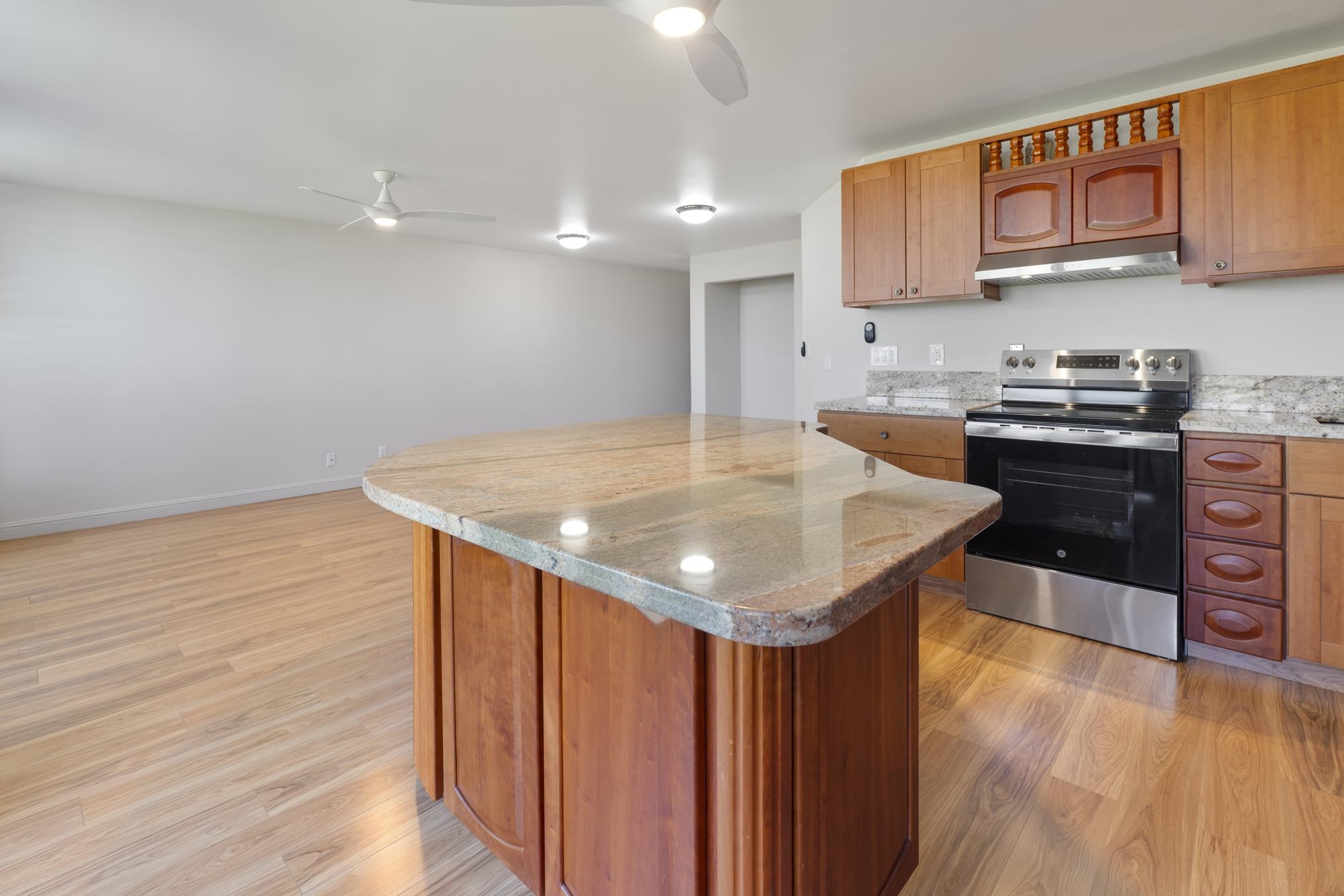 1002 South Kihei Road, Unit 114 Kihei, HI 96753 - Photo 11 of 50 a kitchen with stainless steel appliances granite countertop a sink a stove and a wooden floors