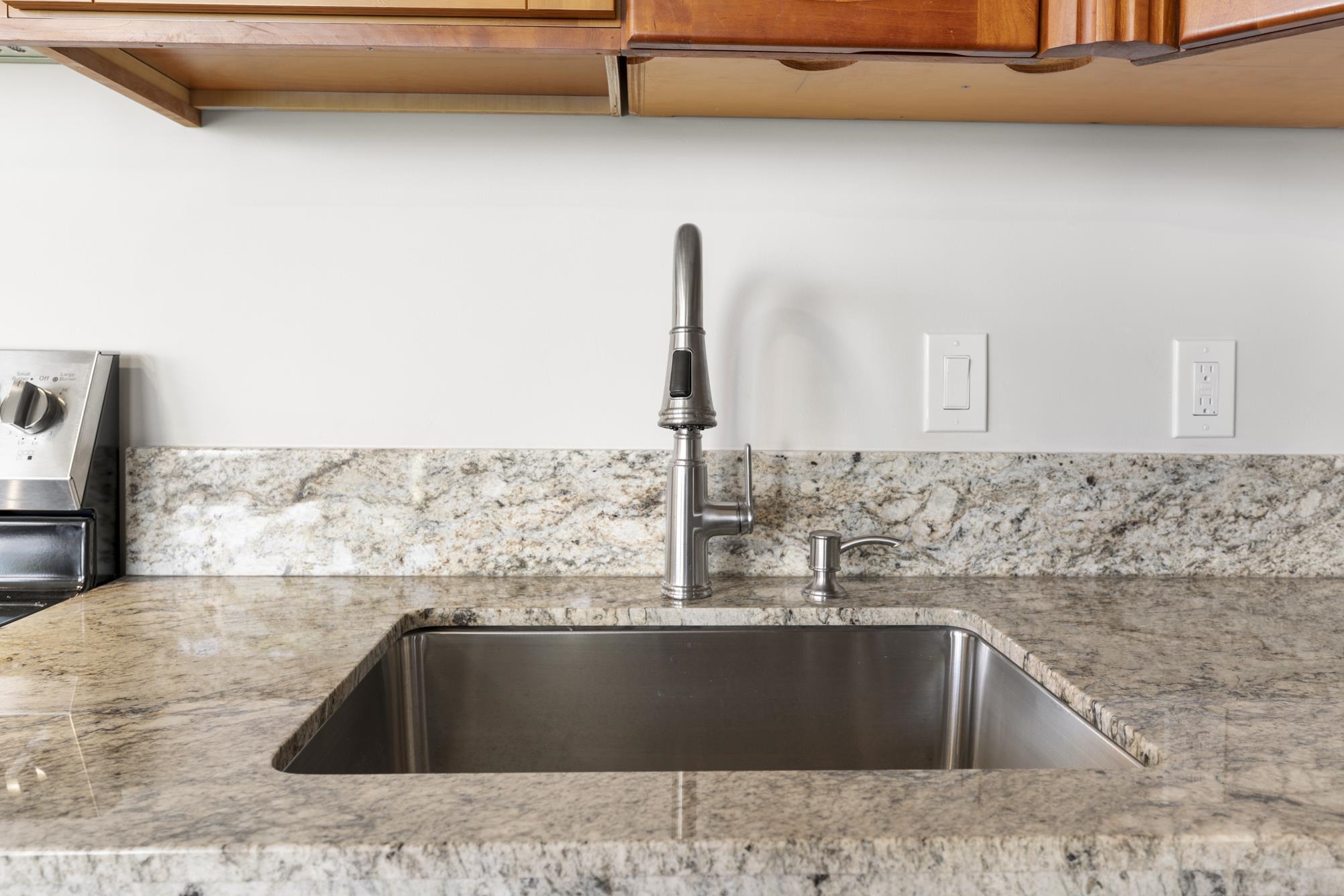 1002 South Kihei Road, Unit 114 Kihei, HI 96753 - Photo 12 of 50 a kitchen with a sink and a granite top