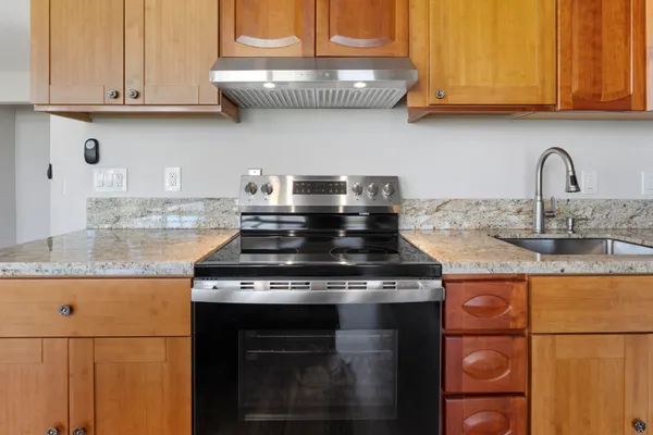 a kitchen with granite countertop stainless steel appliances and cabinets