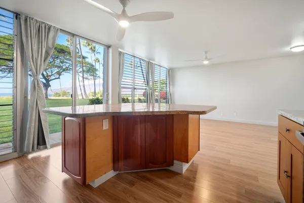 a room with wooden floor and large window