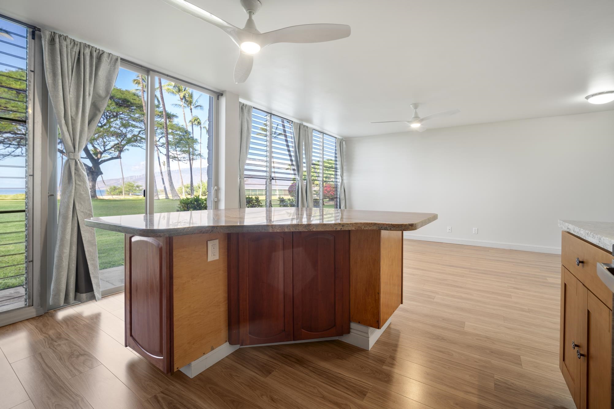 1002 South Kihei Road, Unit 114 Kihei, HI 96753 - Photo 15 of 50 a room with wooden floor and large window