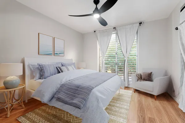 a spacious bedroom with a bed and a couch