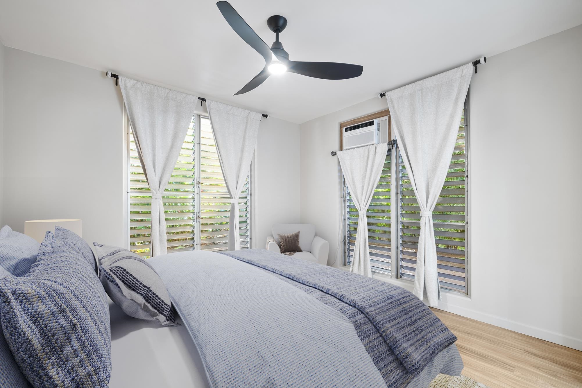 1002 South Kihei Road, Unit 114 Kihei, HI 96753 - Photo 21 of 50 a bedroom with a bed and a large window