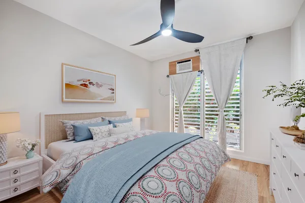 a bedroom with a large bed and a chandelier
