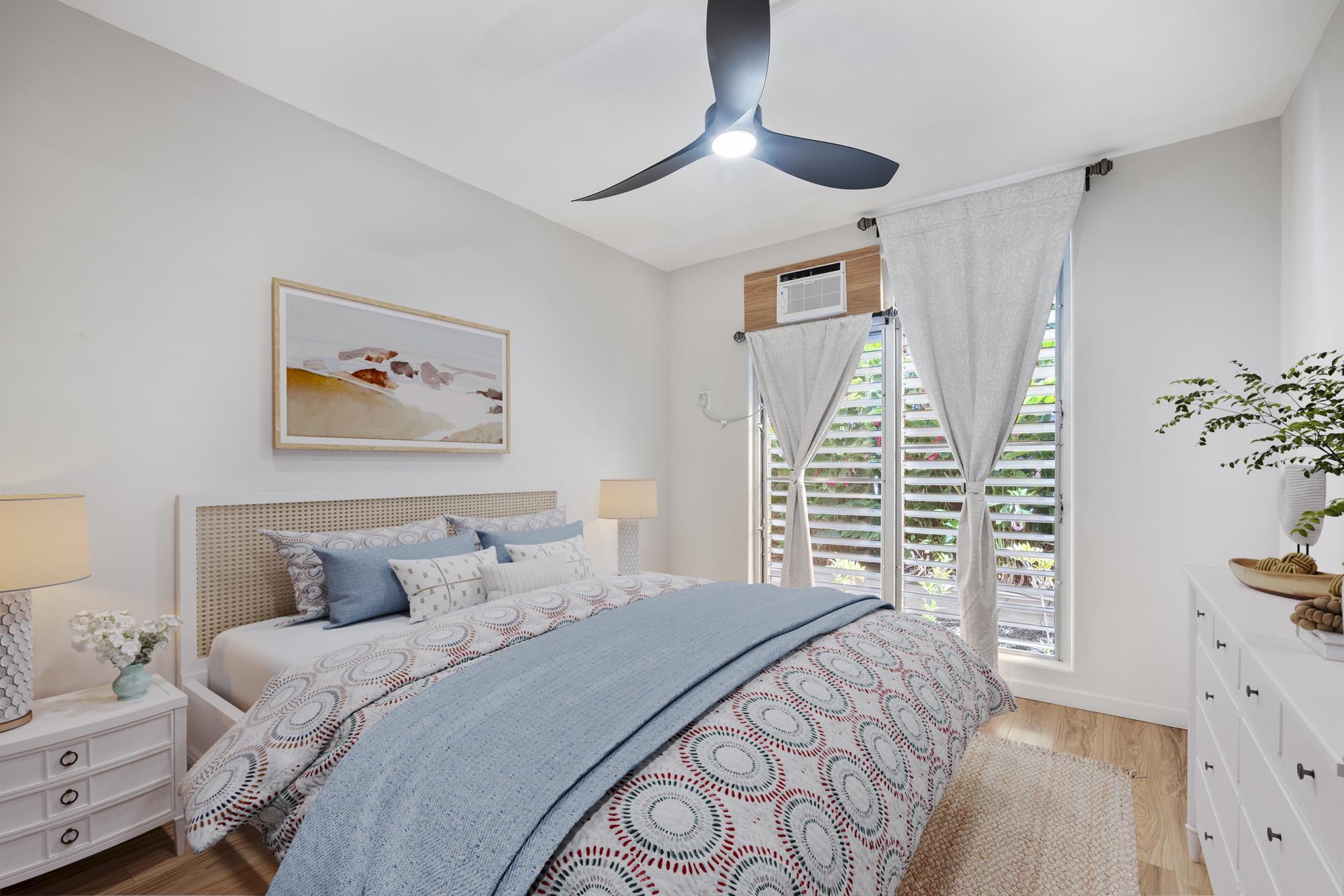 1002 South Kihei Road, Unit 114 Kihei, HI 96753 - Photo 23 of 50 a bedroom with a large bed and a chandelier