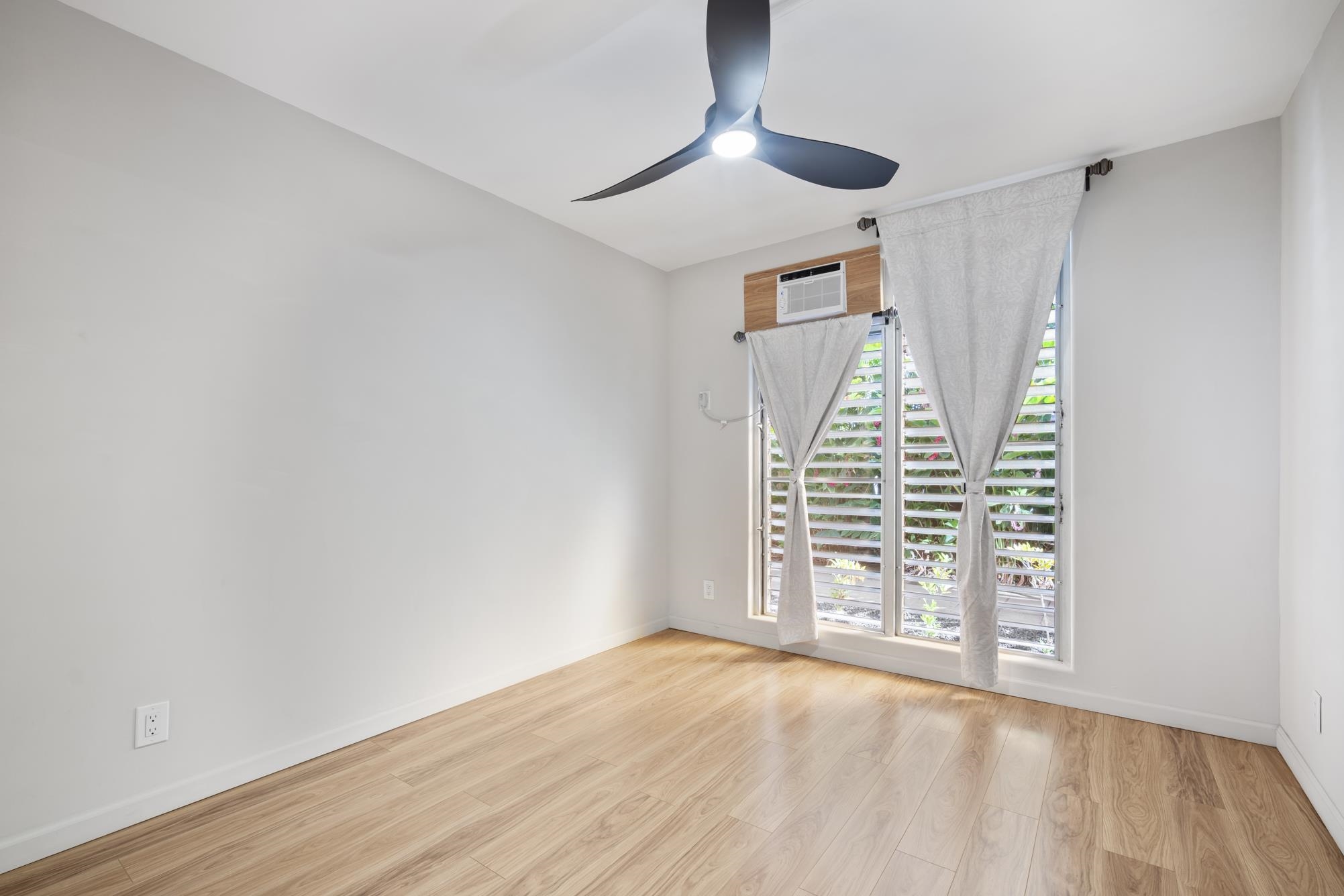 1002 South Kihei Road, Unit 114 Kihei, HI 96753 - Photo 24 of 50 wooden floor in an empty room with a window