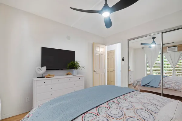 a bedroom with a bed and a flat screen tv