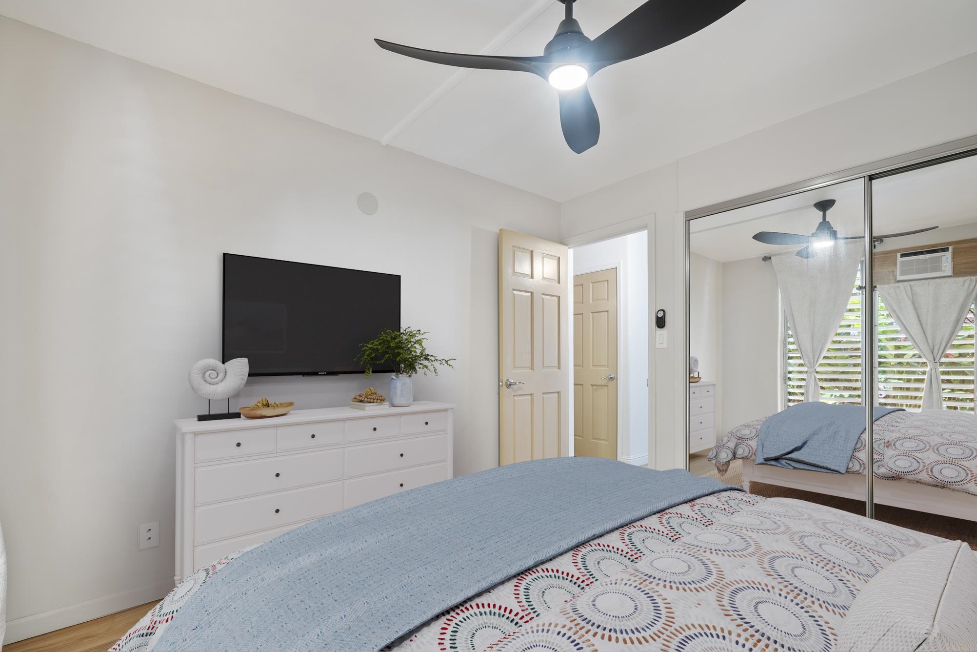 1002 South Kihei Road, Unit 114 Kihei, HI 96753 - Photo 25 of 50 a bedroom with a bed and a flat screen tv