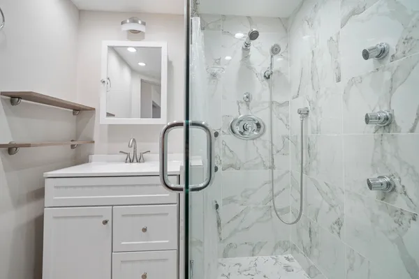 a bathroom with a sink a toilet and shower
