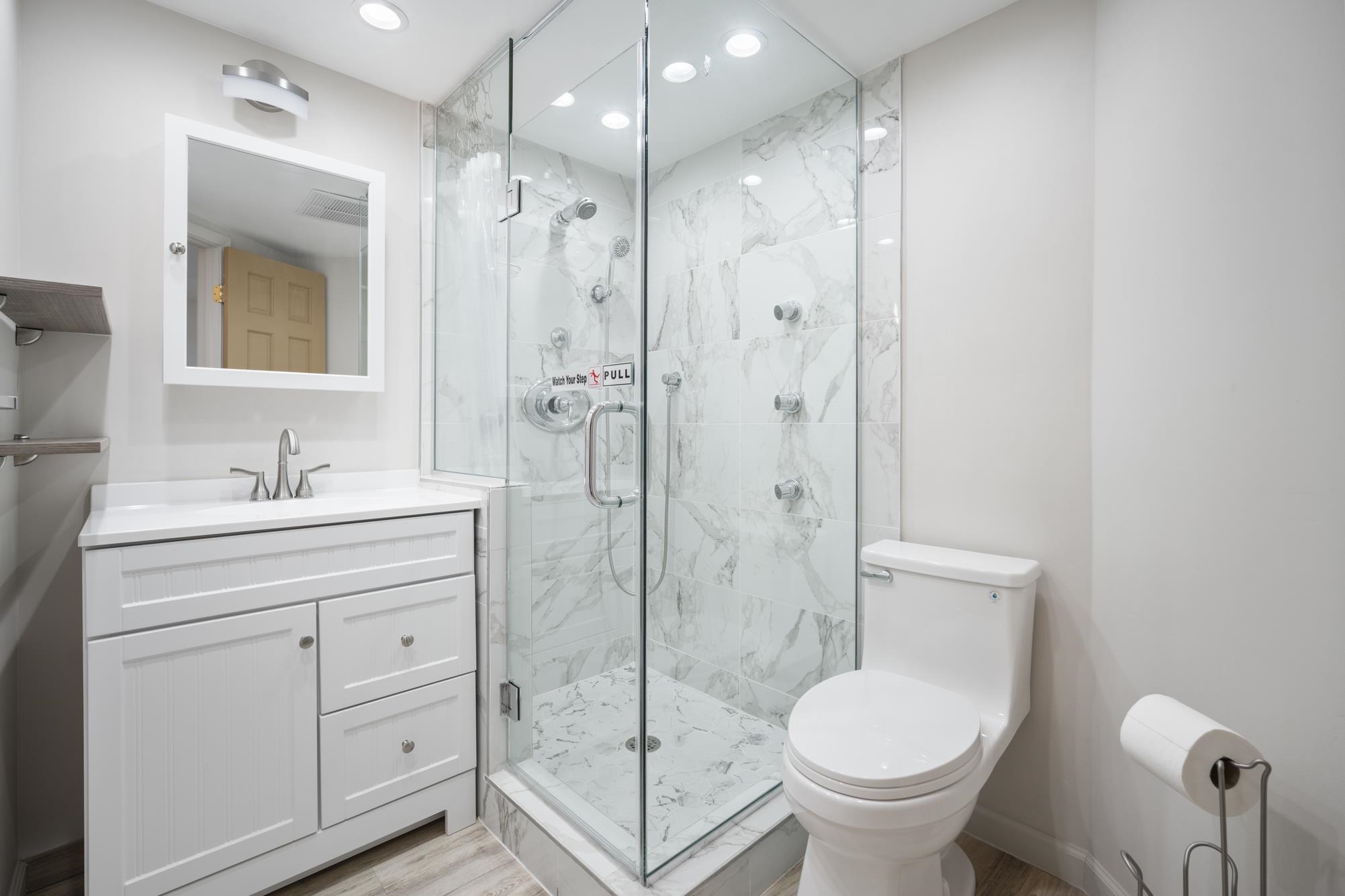 1002 South Kihei Road, Unit 114 Kihei, HI 96753 - Photo 31 of 50 a bathroom with a shower sink mirror and toilet