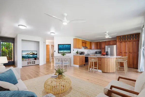 a living room with furniture and kitchen view