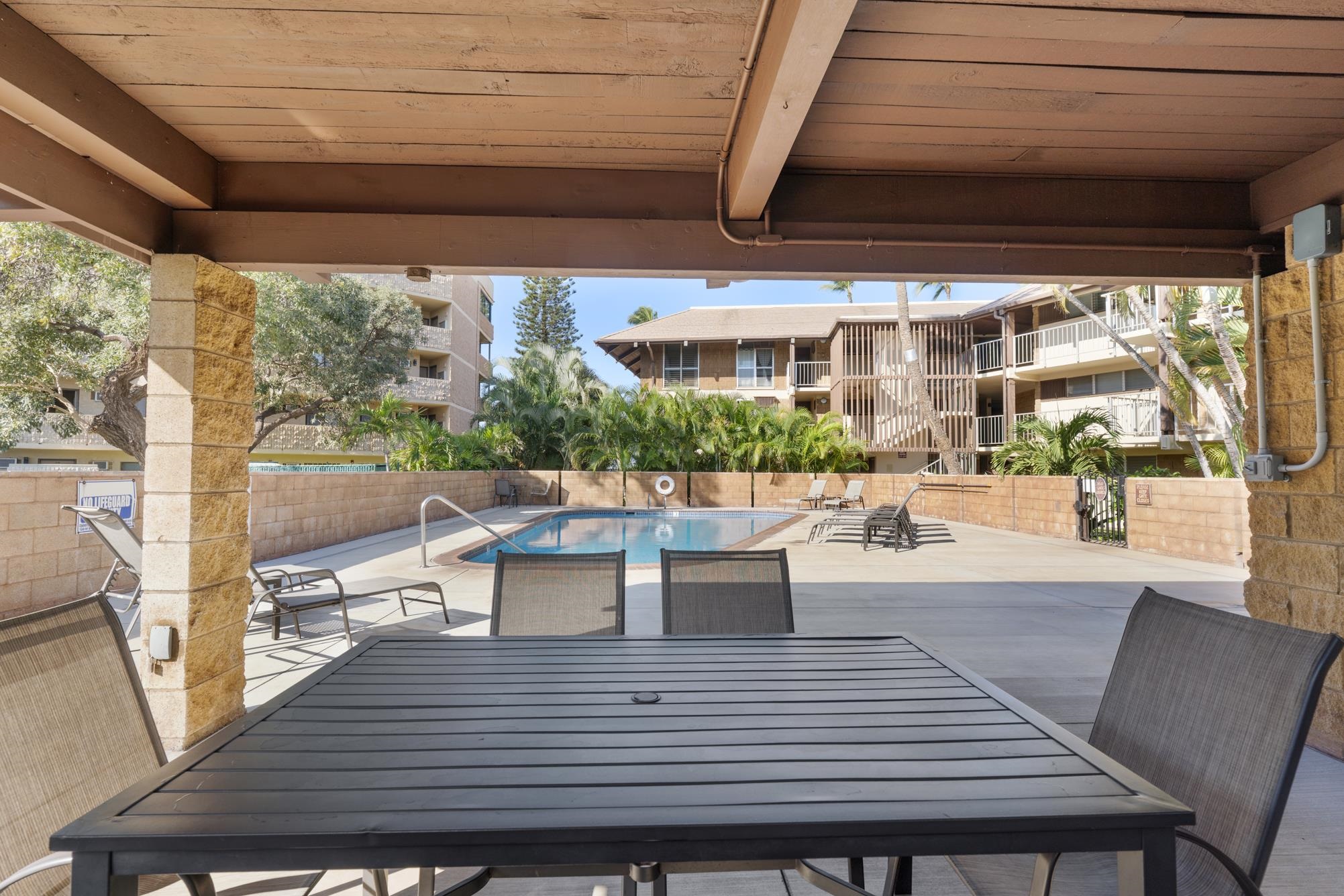 1002 South Kihei Road, Unit 114 Kihei, HI 96753 - Photo 47 of 50 a view of a patio with dining table and chairs