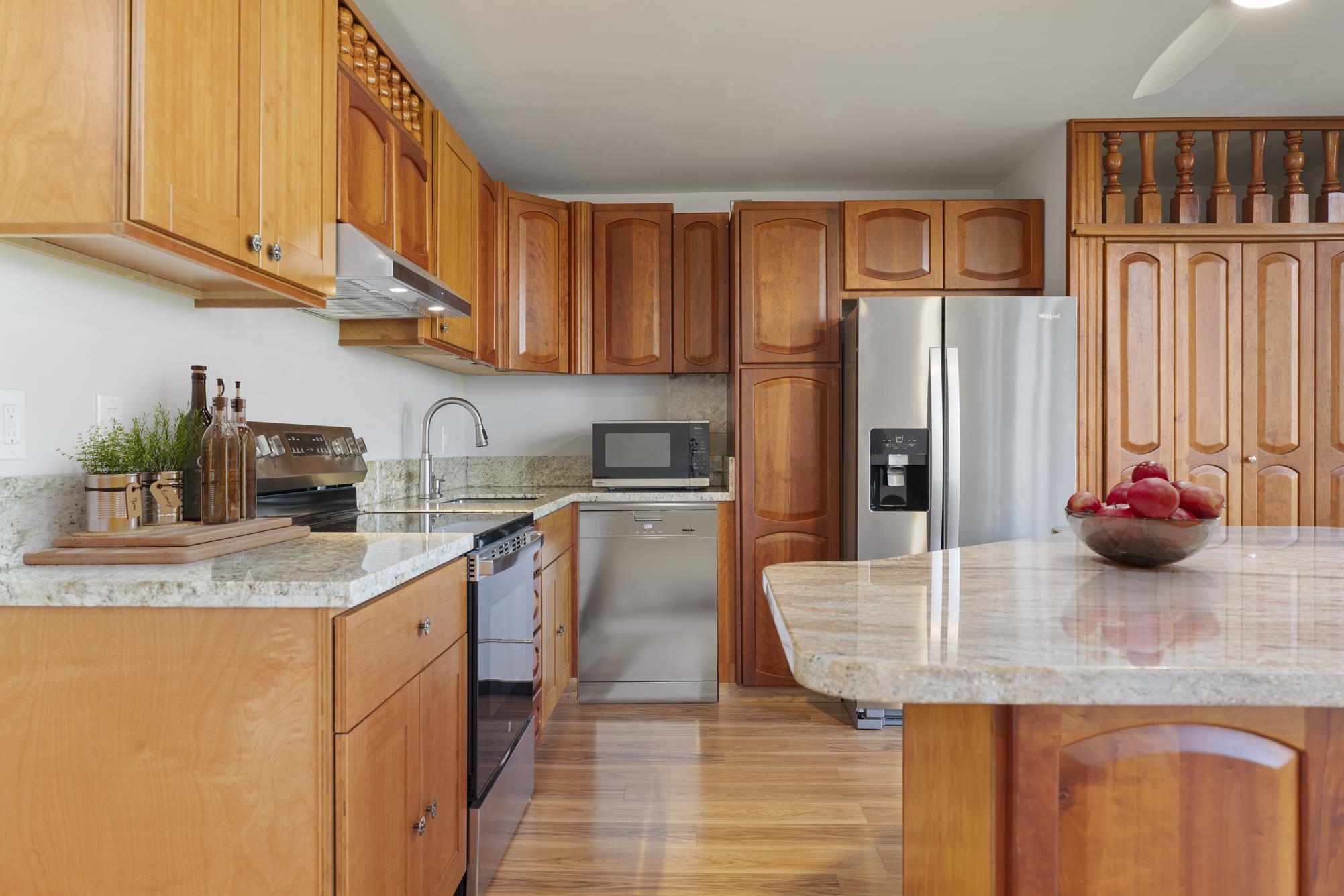 1002 South Kihei Road, Unit 114 Kihei, HI 96753 - Photo 6 of 50 a kitchen with stainless steel appliances granite countertop a sink a refrigerator and cabinets