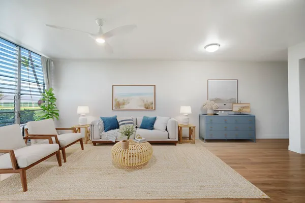 a living room with furniture and a wooden floor