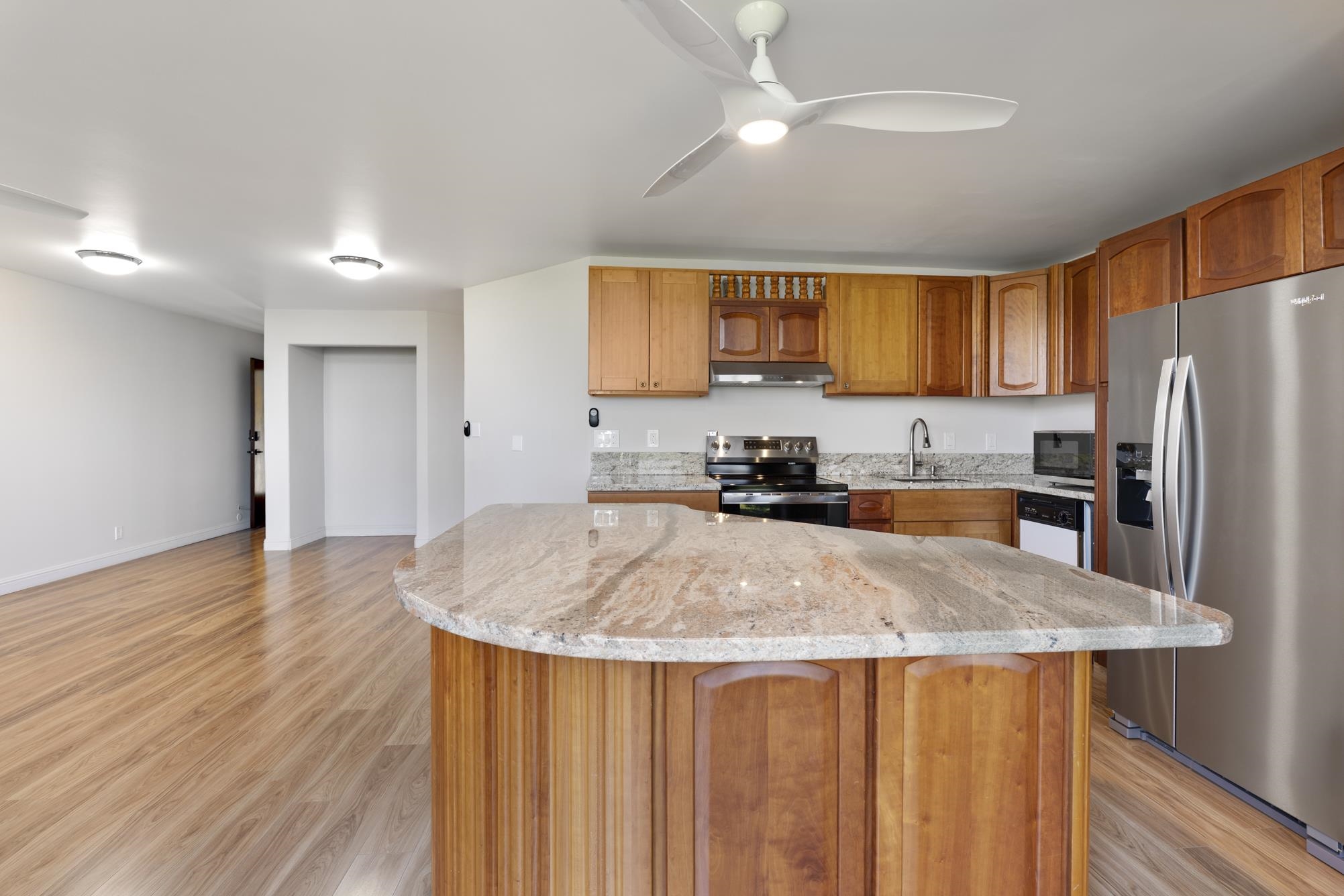 1002 South Kihei Road, Unit 114 Kihei, HI 96753 - Photo 10 of 50 a kitchen with stainless steel appliances granite countertop a sink refrigerator and microwave