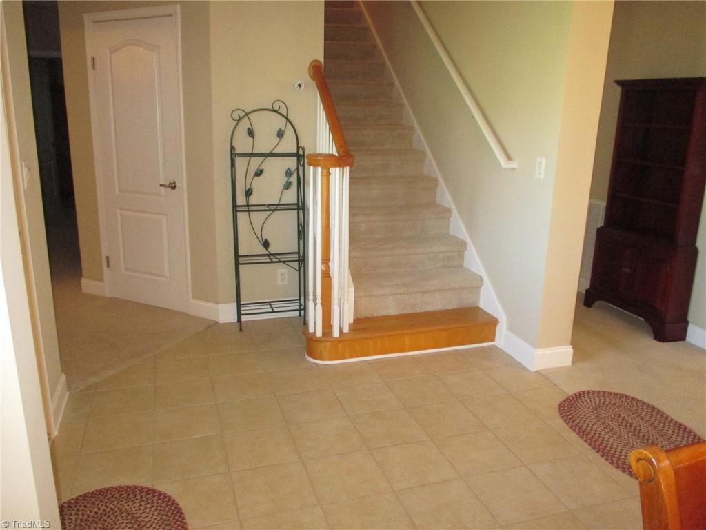 2475 Swicegood Road Linwood, NC 27299 - Photo 17 of 38 FOYER WITH STAIRS TO VERY LARGE HEATED/COOLED ATTIC(PARTIALLY FINISHED-SHEET ROCK HUNG AND PATCHED)