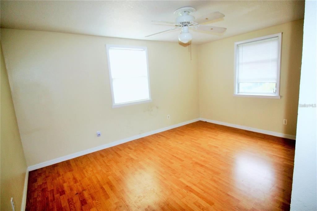 521 20th Street Southwest, Unit C Winter Haven, FL 33880 - Photo 8 of 18 wooden floor in an empty room with a window