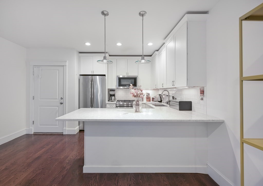 a view of kitchen with center island and stainless steel appliances