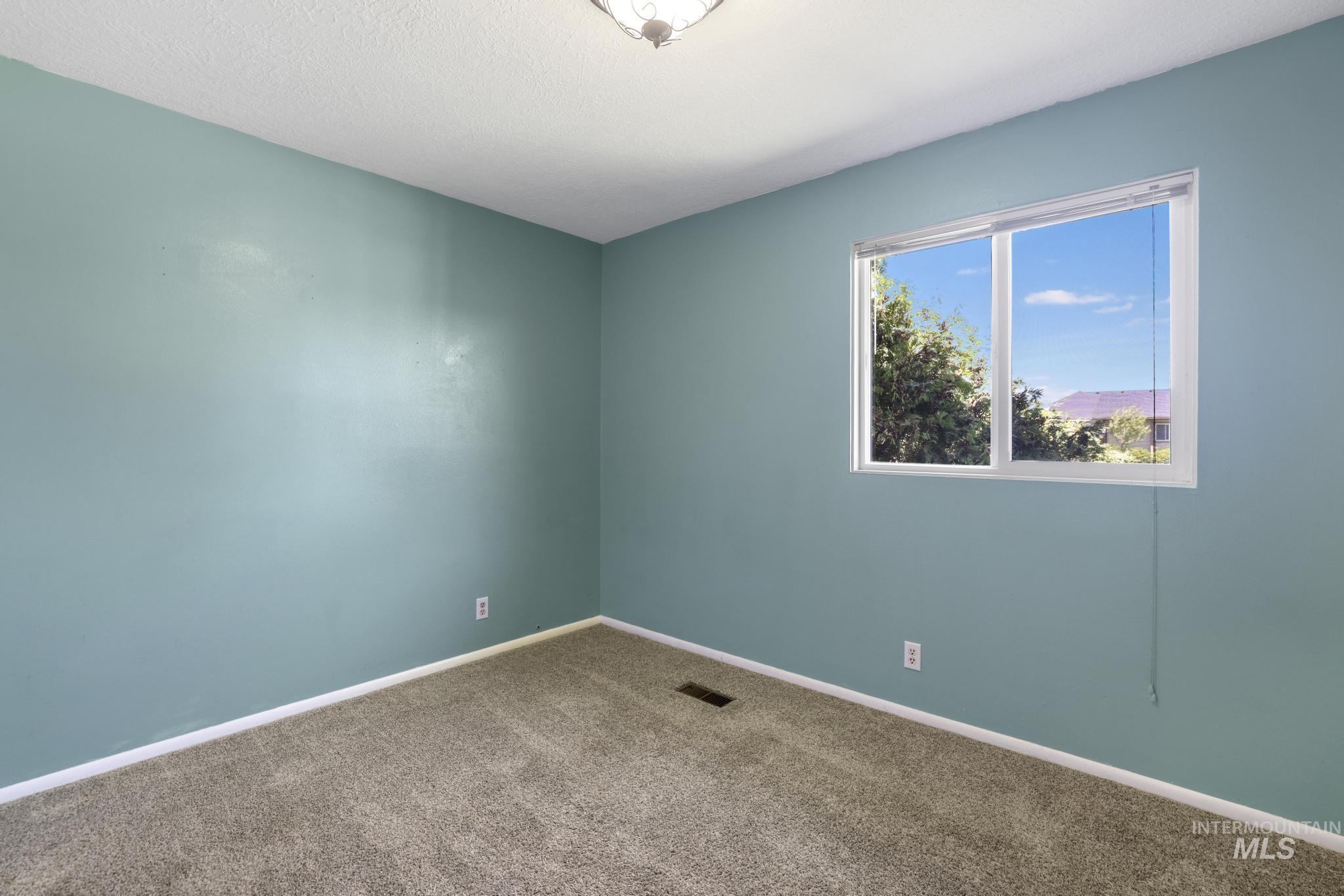 712 Locust Street Kimberly, ID 83341 - Photo 17 of 26 Neutral-toned walls complement plush carpeting
