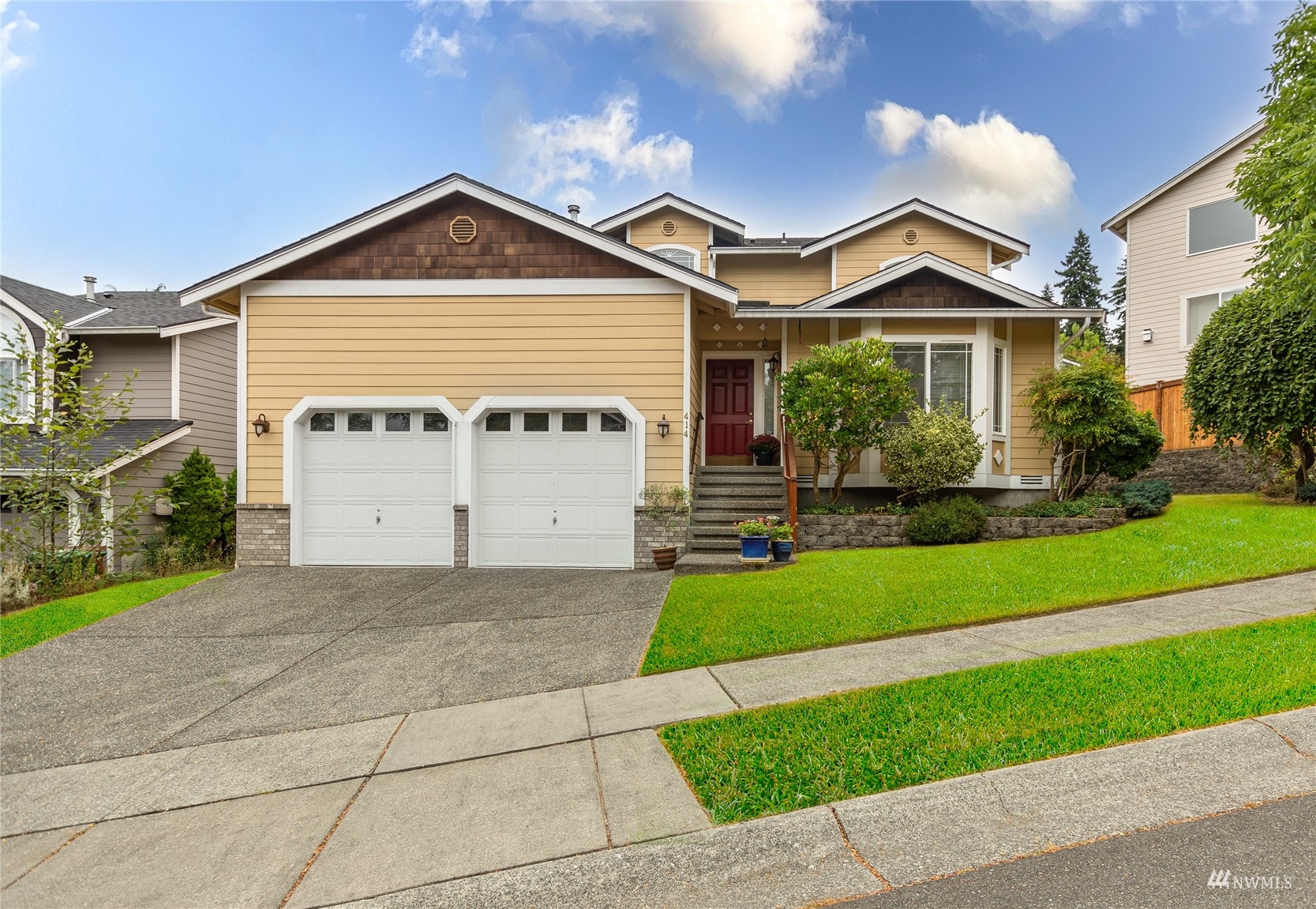 414 170th Place Southeast Bothell, WA 98012 - Photo 1 of 40 a front view of a house with a yard and garage