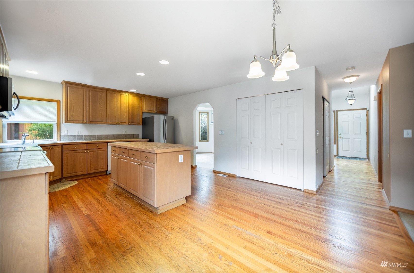 414 170th Place Southeast Bothell, WA 98012 - Photo 12 of 40 a view of a kitchen with a sink and dishwasher a refrigerator with wooden floor