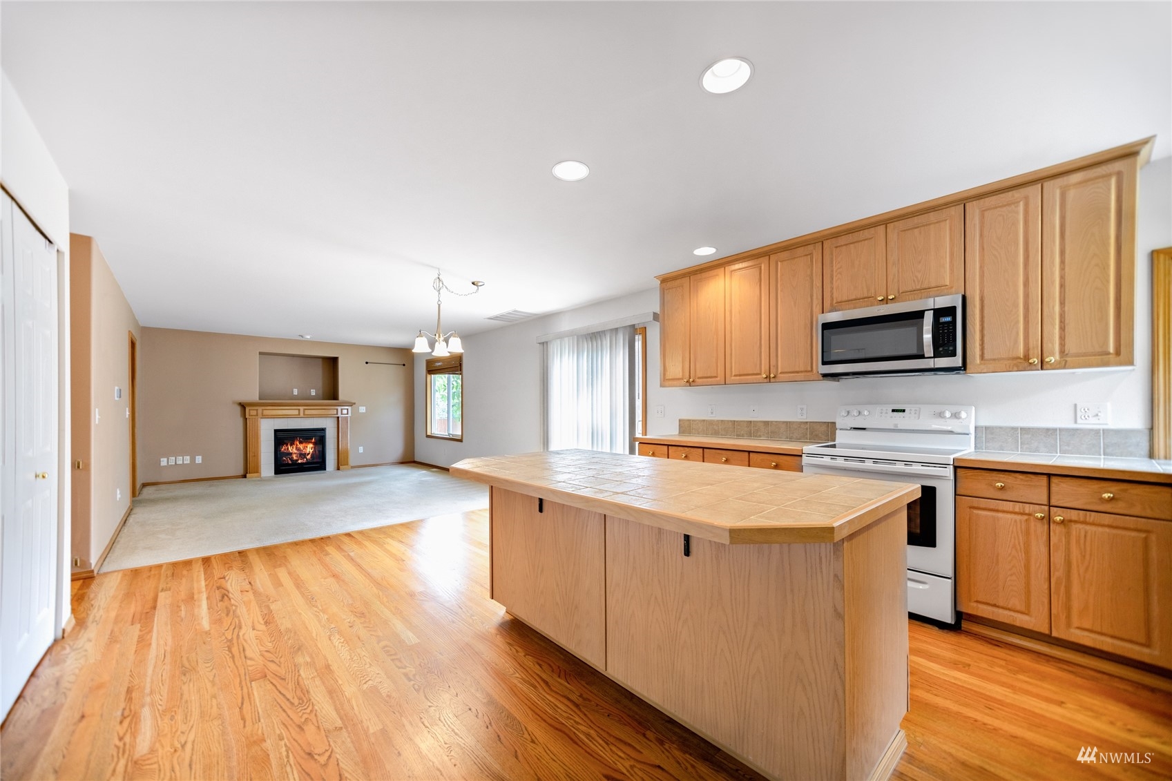 414 170th Place Southeast Bothell, WA 98012 - Photo 8 of 40 a large kitchen with cabinets wooden floor and stainless steel appliances