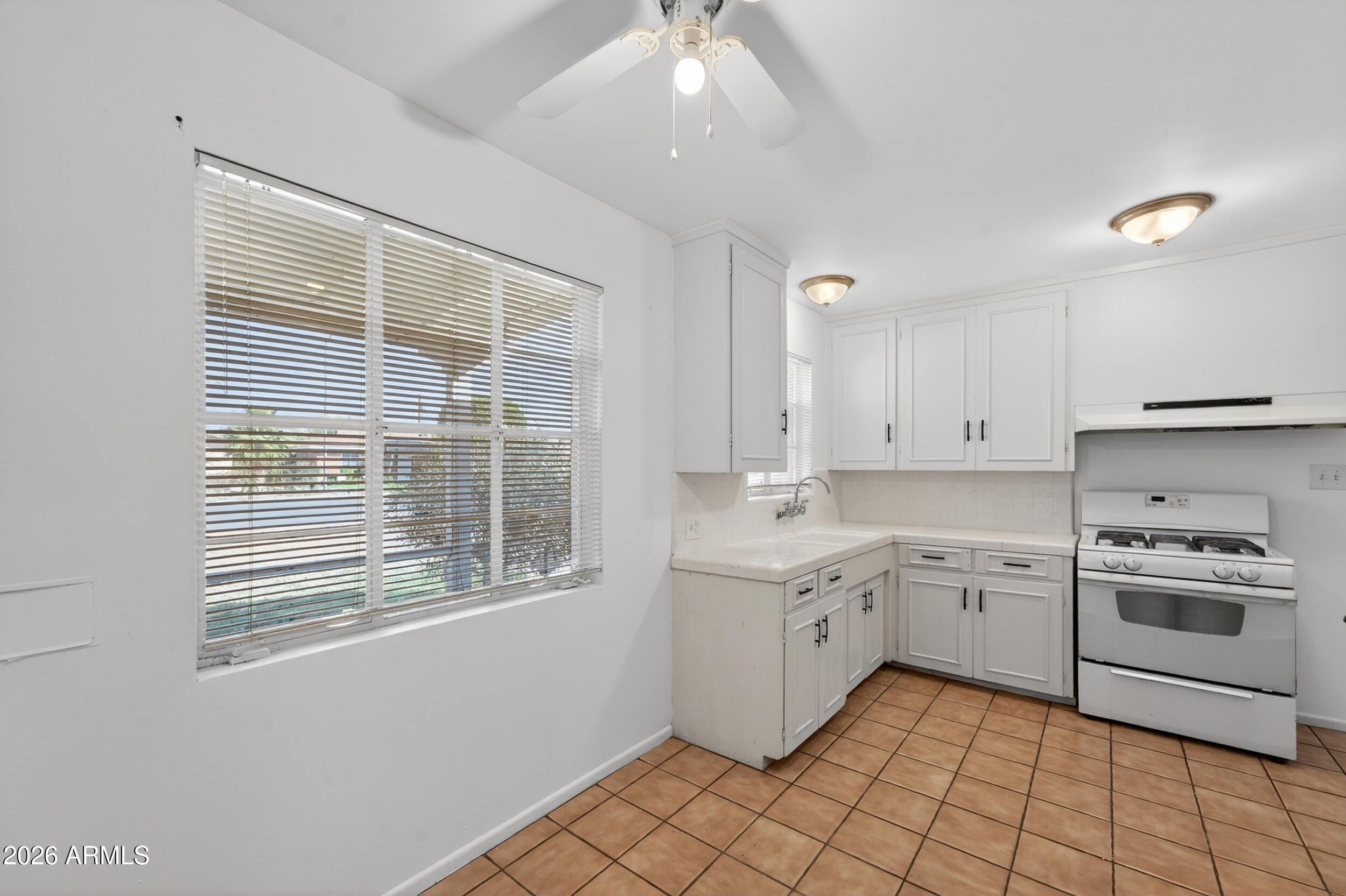 2233 West Flower Street Phoenix, AZ 85015 - Photo 9 of 36 a kitchen with sink cabinets and appliances