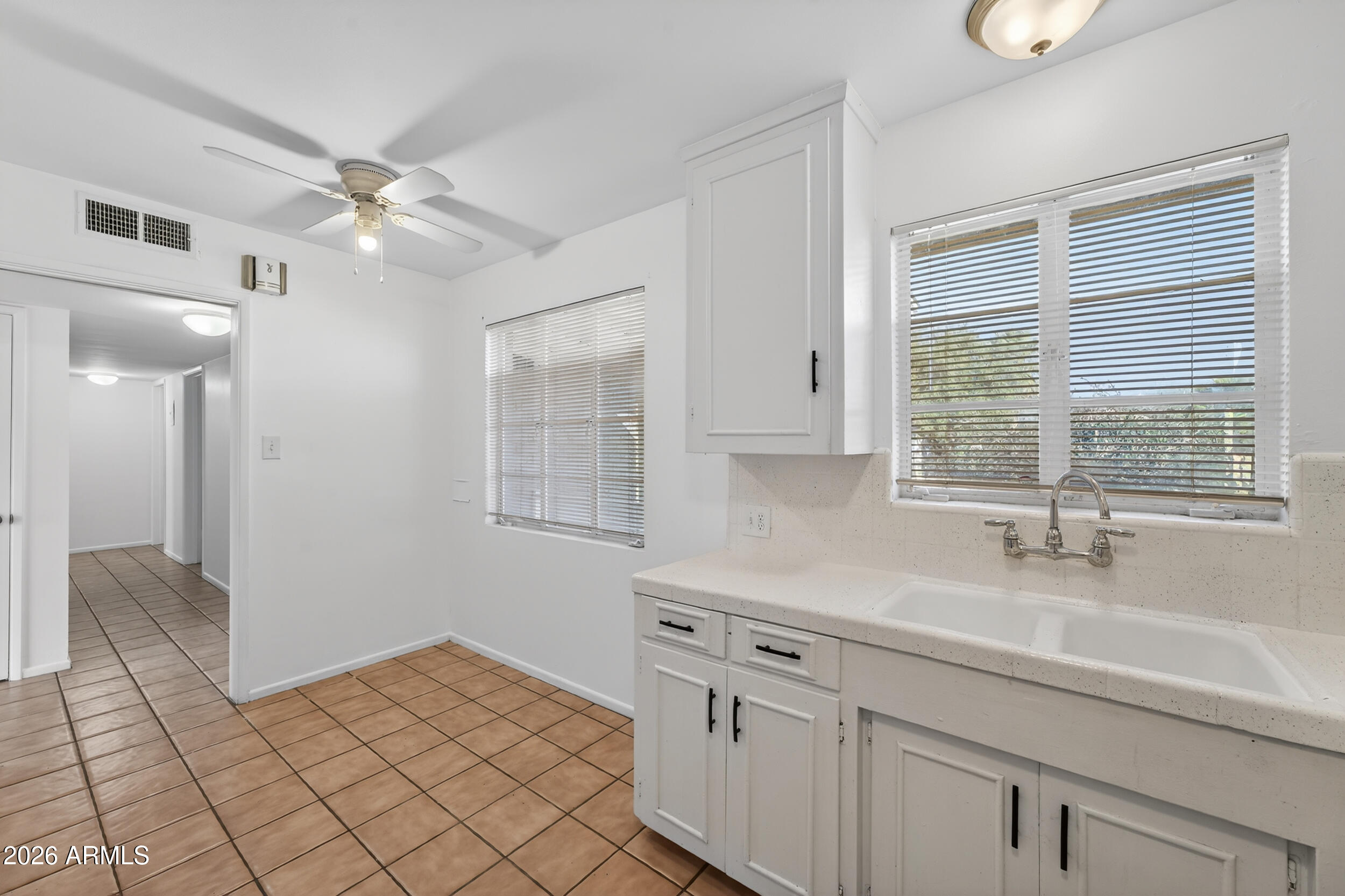 2233 West Flower Street Phoenix, AZ 85015 - Photo 10 of 36 a kitchen with a sink cabinets and window