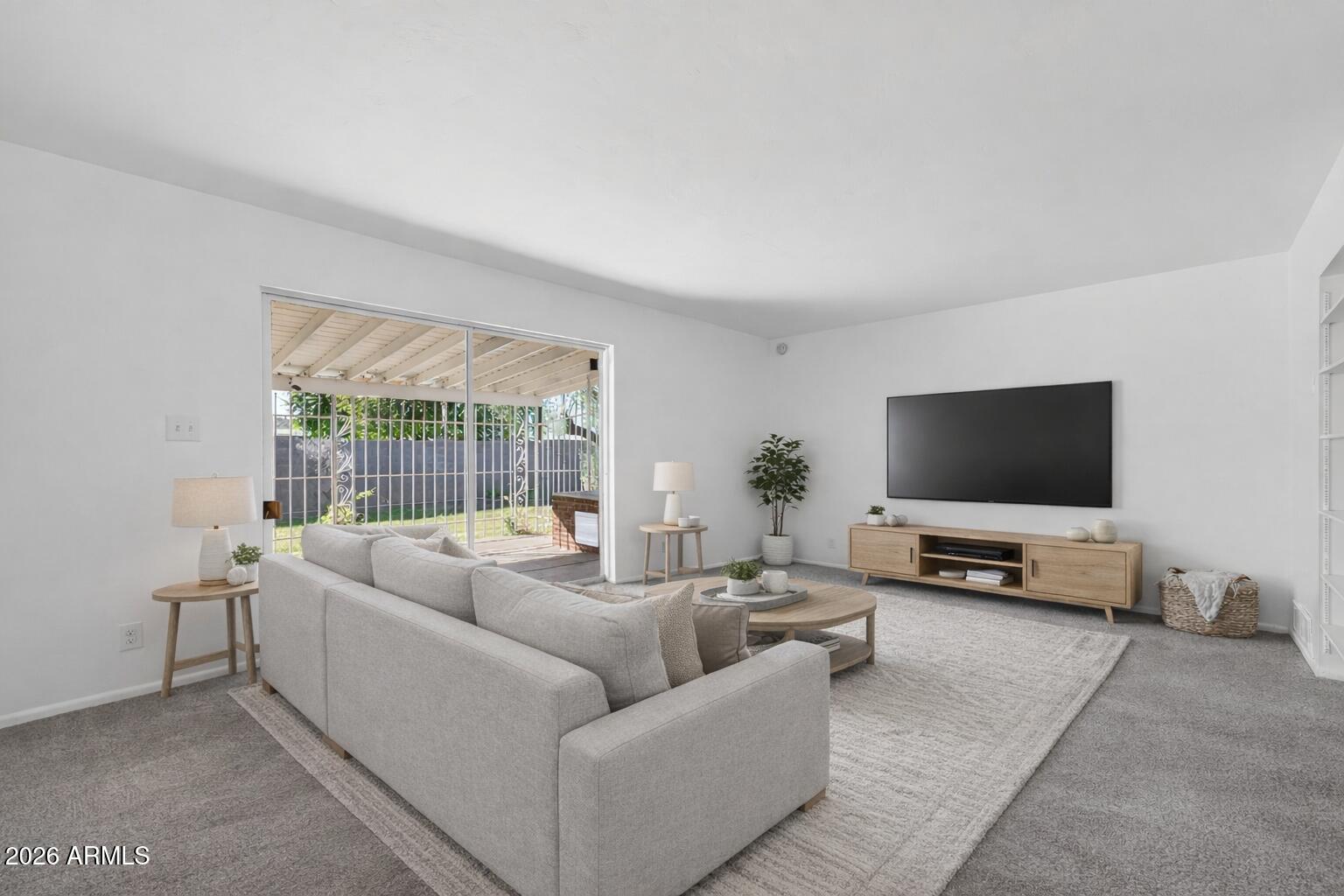 2233 West Flower Street Phoenix, AZ 85015 - Photo 11 of 36 a living room with furniture and a flat screen tv