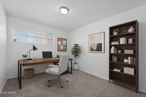 a view of a workspace with a bookshelf