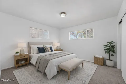 a bedroom with a bed and a couch