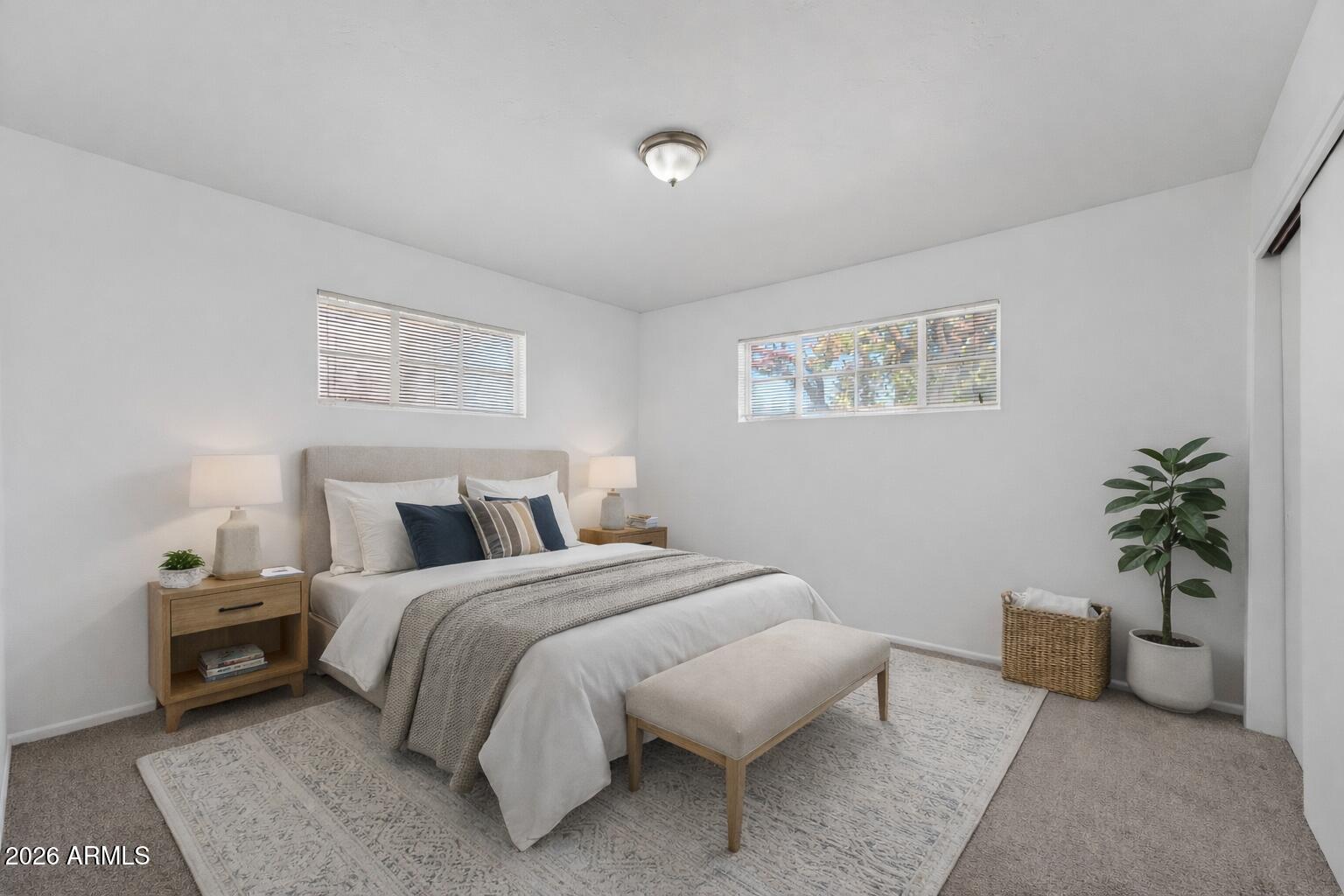 2233 West Flower Street Phoenix, AZ 85015 - Photo 17 of 36 a bedroom with a bed and a couch