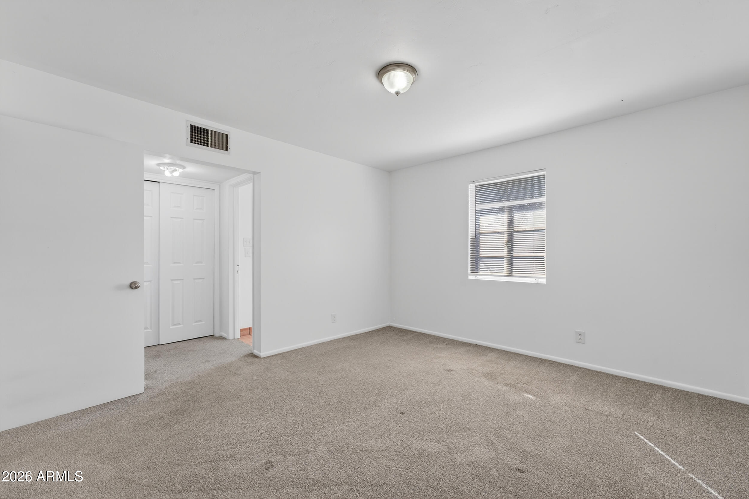 2233 West Flower Street Phoenix, AZ 85015 - Photo 23 of 36 an empty room with windows and closet