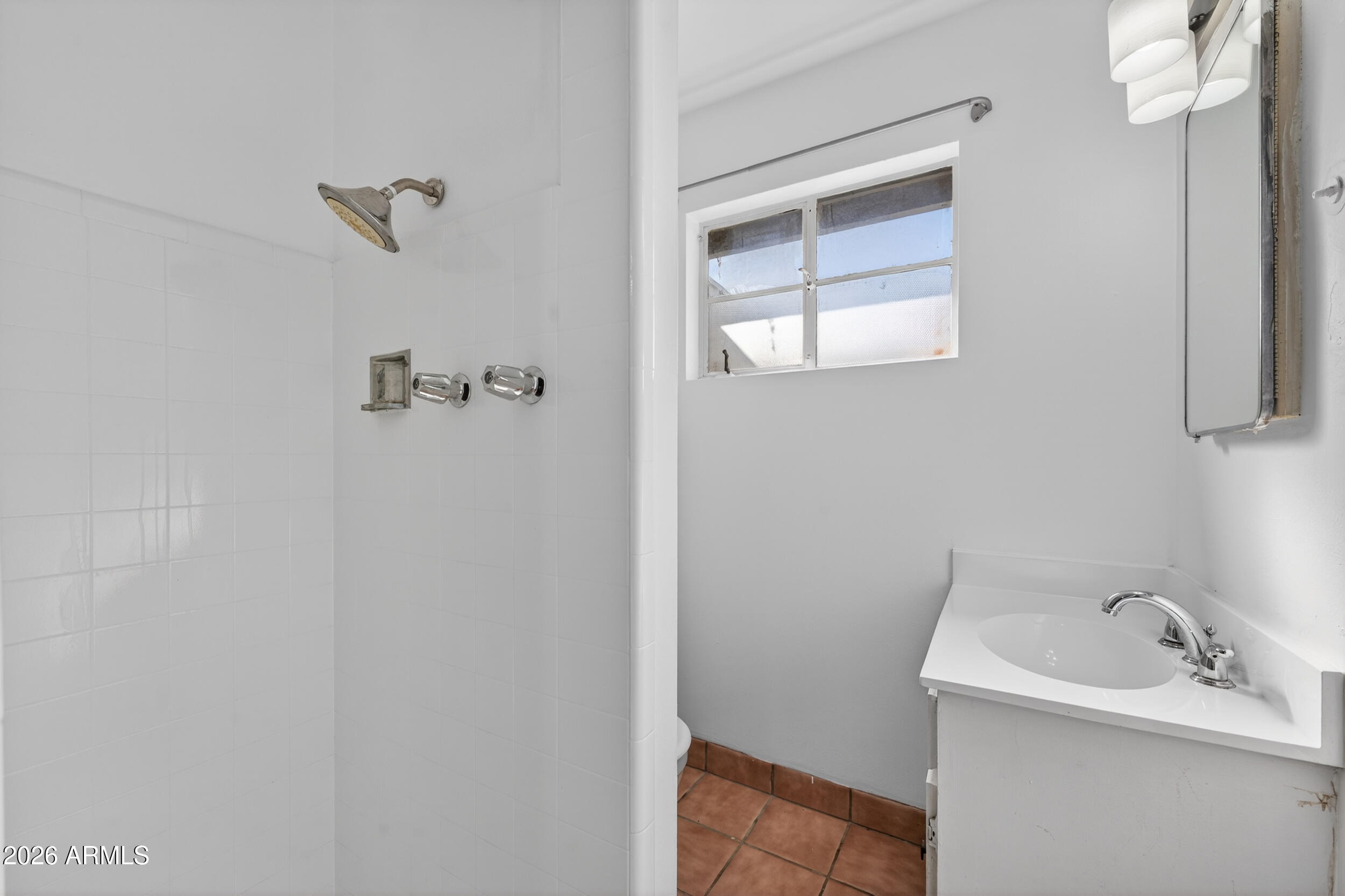 2233 West Flower Street Phoenix, AZ 85015 - Photo 25 of 36 a bathroom with a sink and a mirror