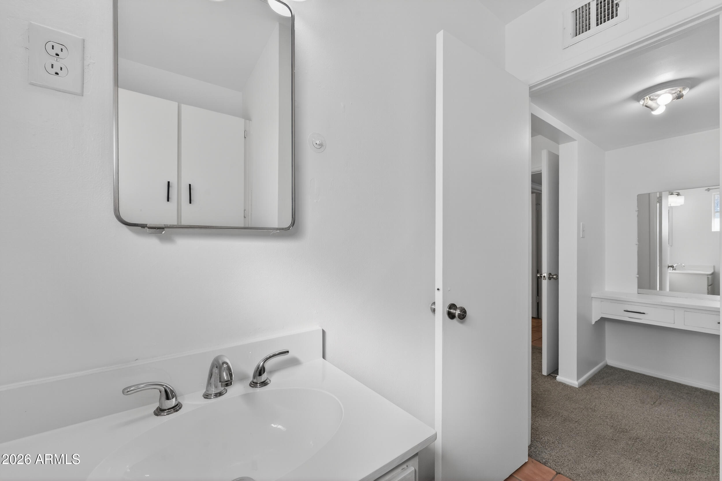 2233 West Flower Street Phoenix, AZ 85015 - Photo 26 of 36 a bathroom with a sink and mirror