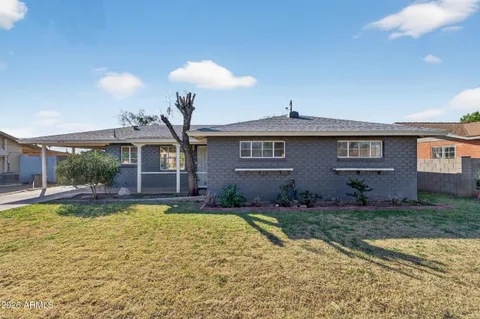 a view of a house with swimming pool and a yard