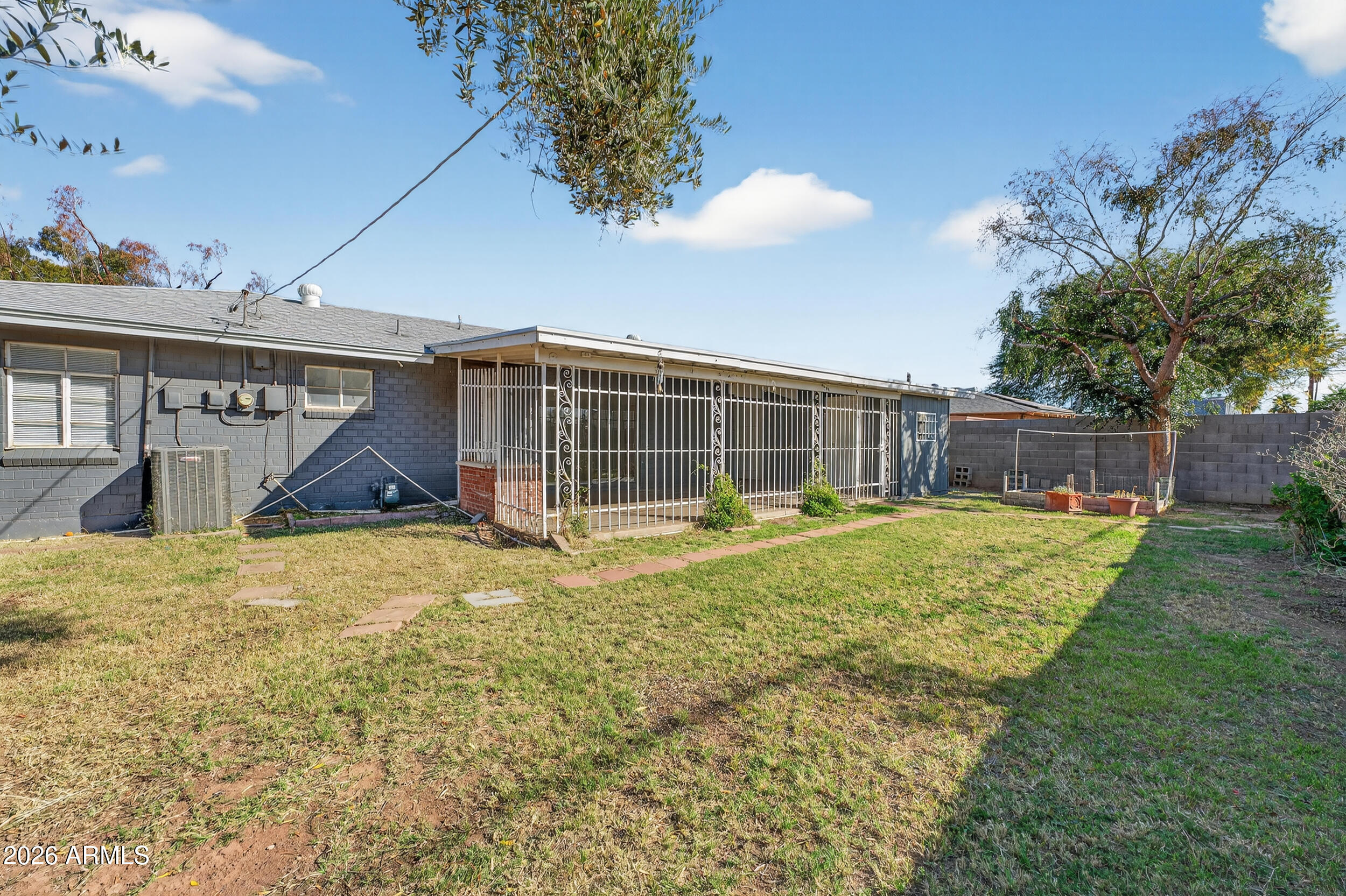 2233 West Flower Street Phoenix, AZ 85015 - Photo 31 of 36 a view of a house with a yard and garage
