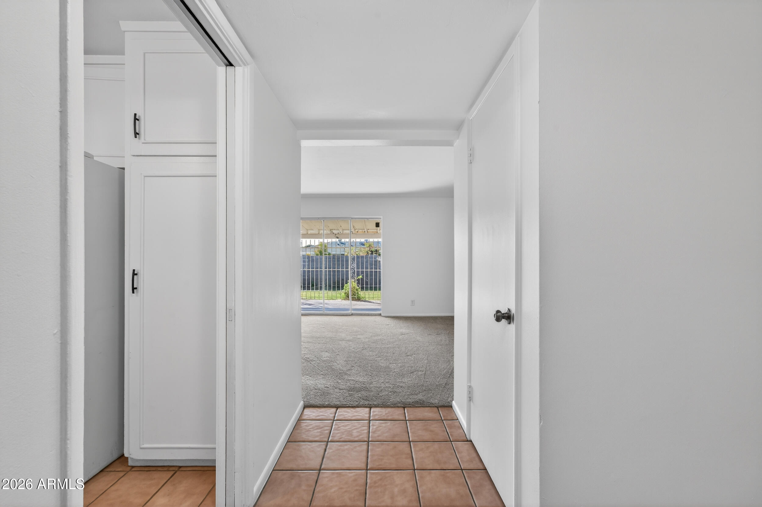 2233 West Flower Street Phoenix, AZ 85015 - Photo 6 of 36 a view of a hallway with wooden floor and a bathroom