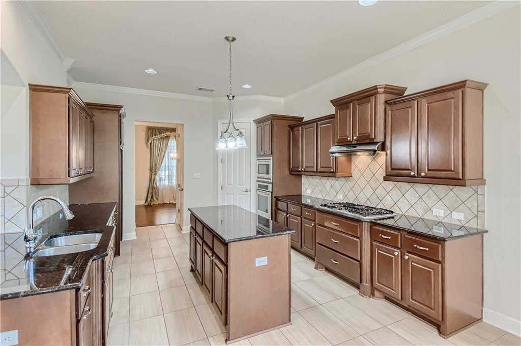 3822 Remington Road Cedar Park, TX 78613 - Photo 9 of 31 a kitchen with stainless steel appliances granite countertop a sink and a refrigerator