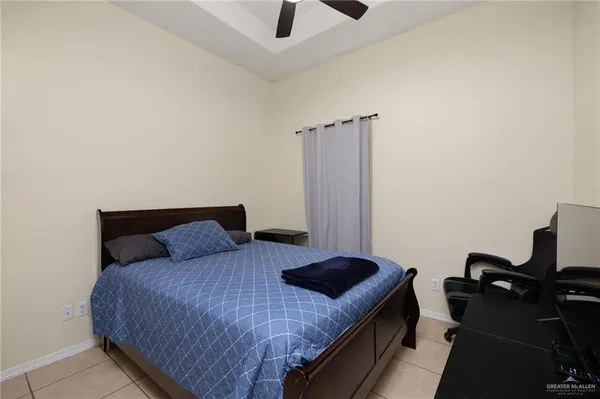 a bedroom with a bed and a ceiling fan