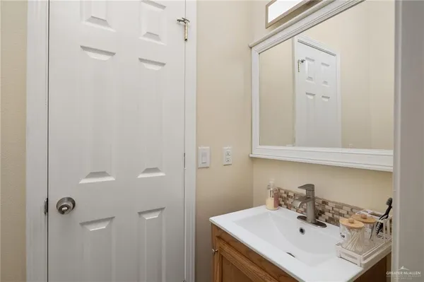 a bathroom with a sink a mirror and shower