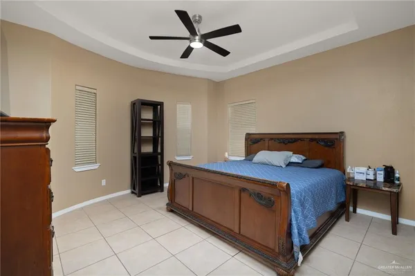 a bedroom with a bed and a ceiling fan