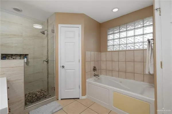 a bathroom with a bathtub and shower